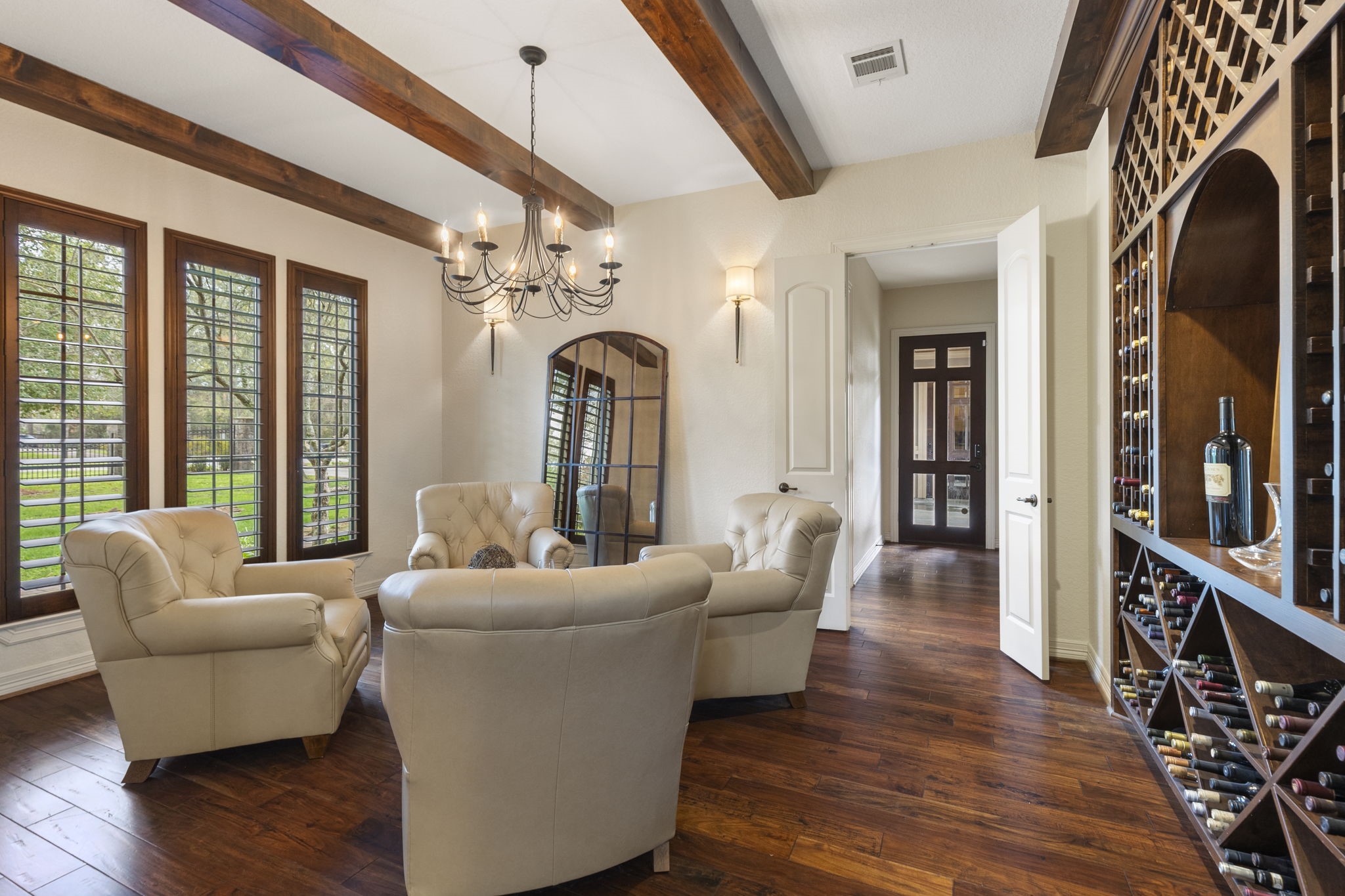 28227 KAILEES Court Spring, TX 77386 - Photo 11 of 48 Elegant Formal Dining or Executive Lounge framed by an arched entry, rich wood flooring, and beam-accented ceiling. Tall shuttered windows, designer lighting, and wall sconces.