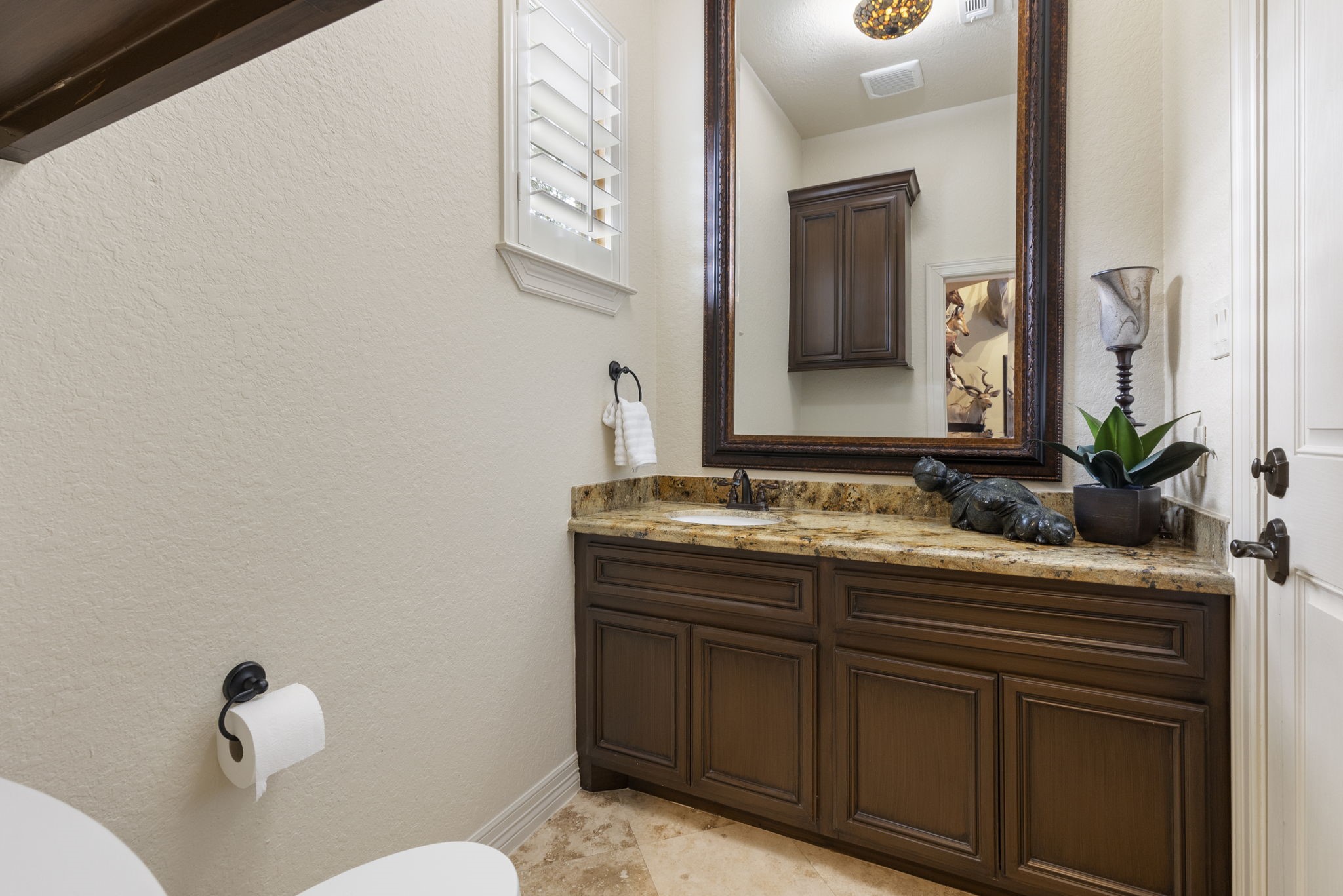 28227 KAILEES Court Spring, TX 77386 - Photo 21 of 48 Convenient Game Room powder bath ideal for guests while entertaining, featuring Travertine flooring, granite vanity, and direct access to the backyard, pool area, and outdoor shower.