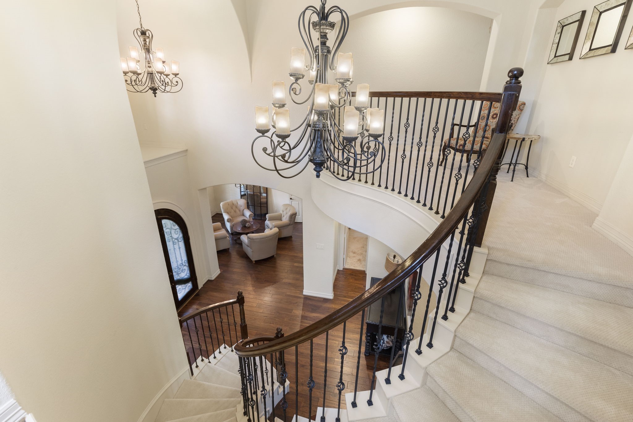 28227 KAILEES Court Spring, TX 77386 - Photo 23 of 48 Elegant staircase with wrought iron spindles, creating a striking architectural transition between the home’s main and upper levels.