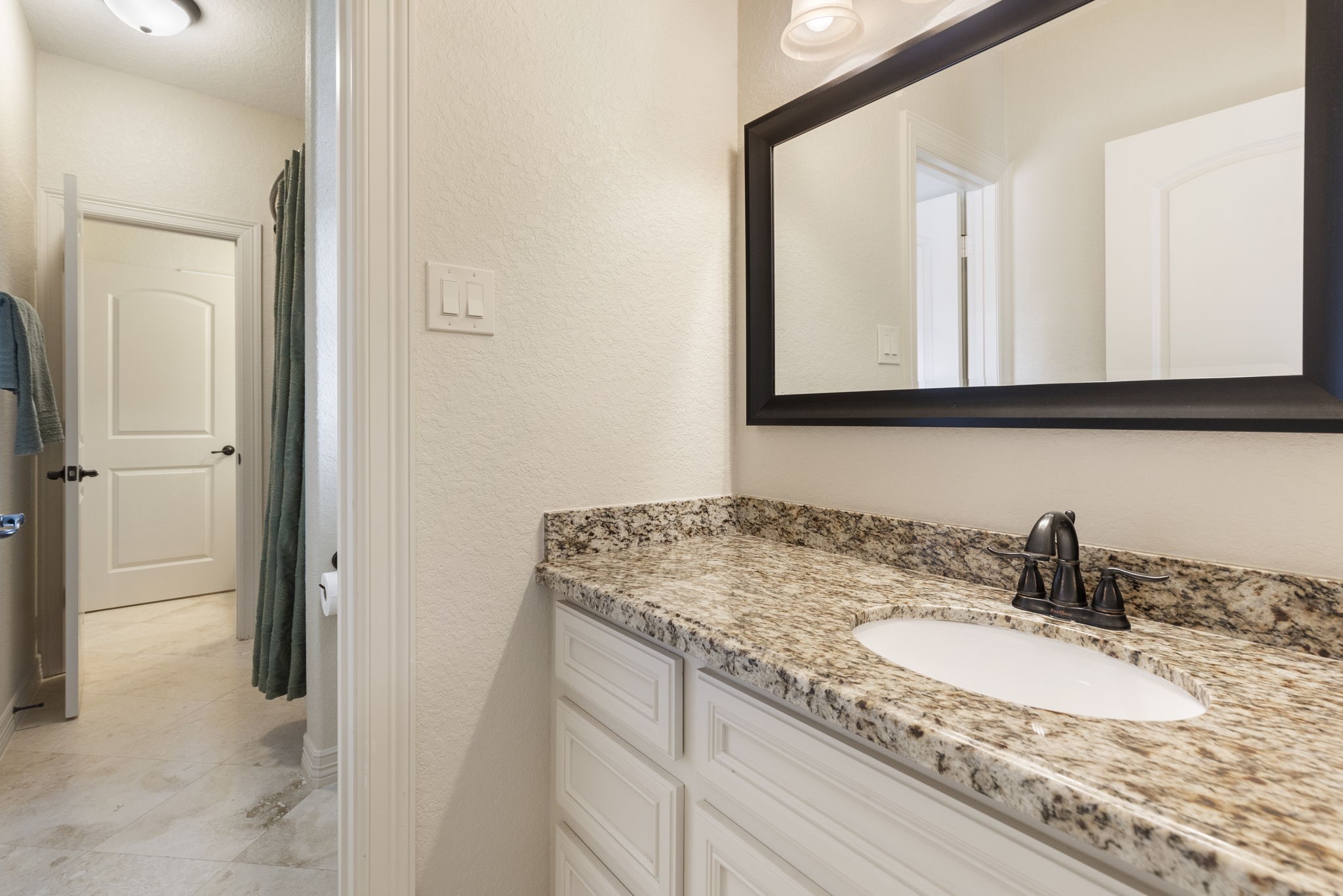 28227 KAILEES Court Spring, TX 77386 - Photo 28 of 48 a bathroom with a granite countertop sink a mirror and a shower