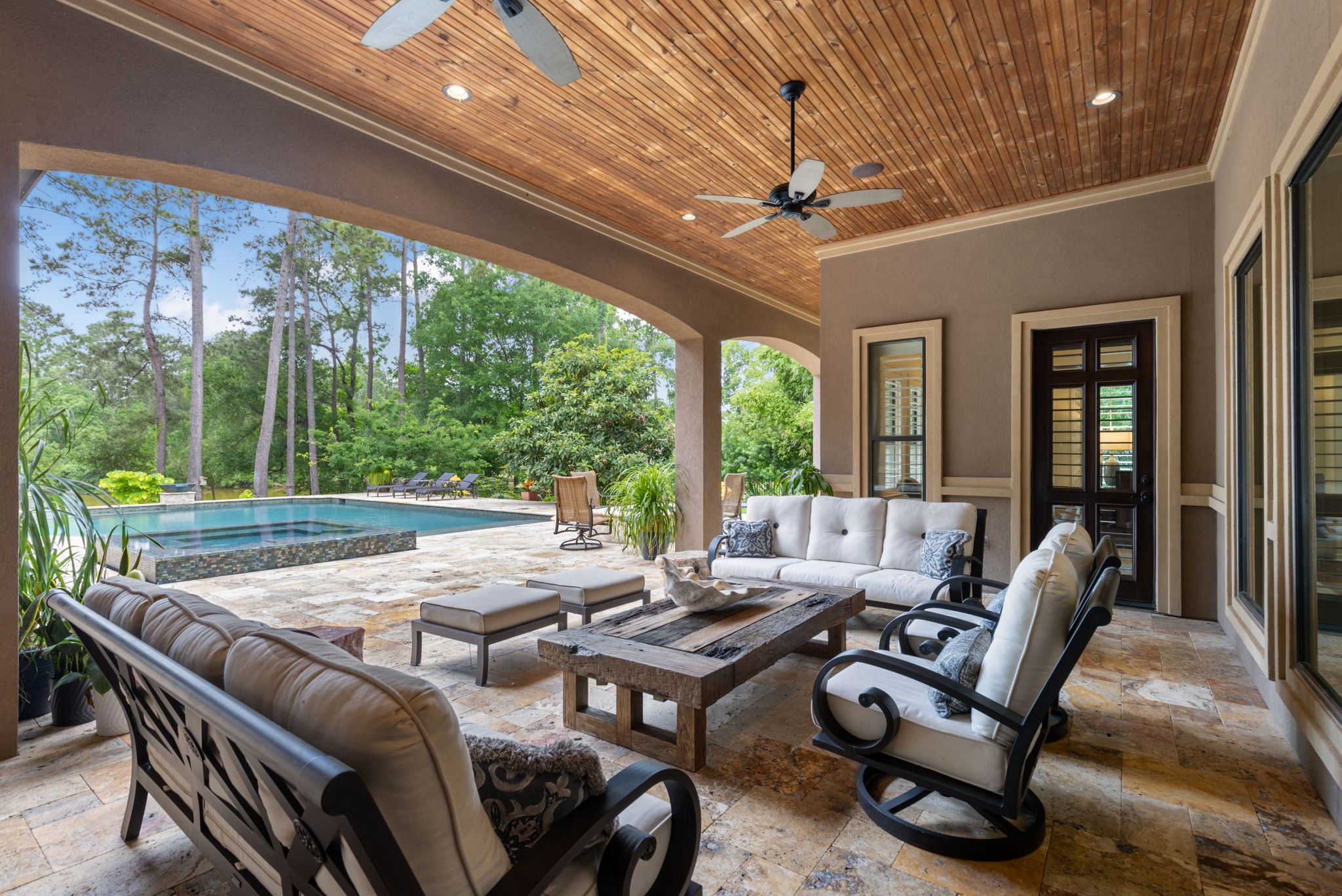 28227 KAILEES Court Spring, TX 77386 - Photo 40 of 48 Expansive covered patio just off the Breakfast and Game Rooms with a wood-paneled ceiling, ceiling fans, and integrated sound system—perfect for indoor/outdoor entertaining.