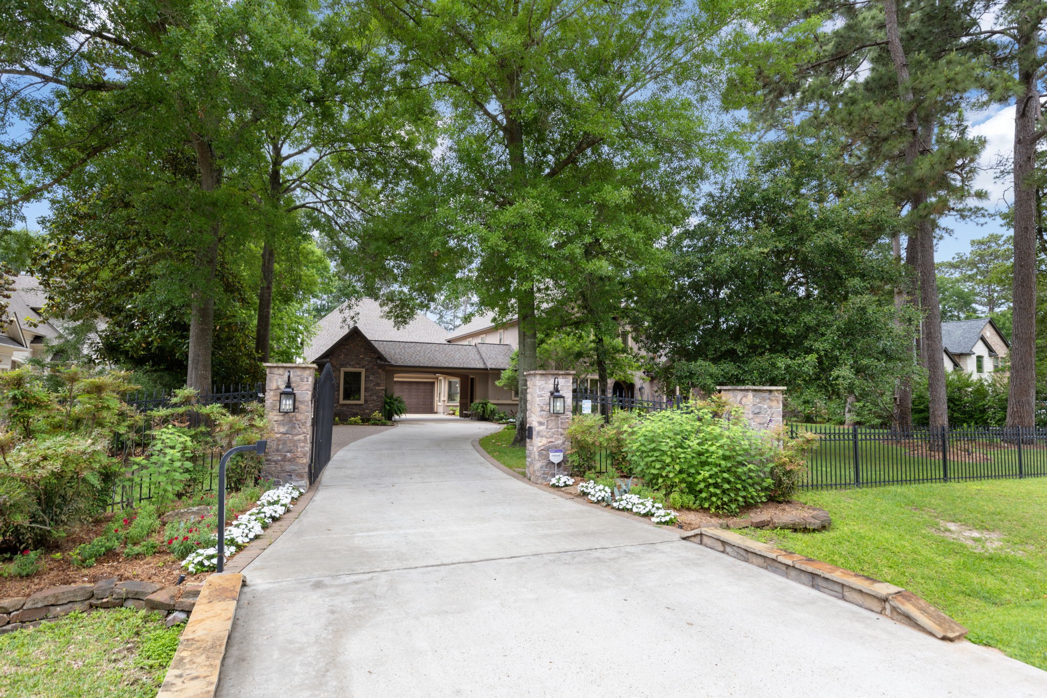 28227 KAILEES Court Spring, TX 77386 - Photo 6 of 48 Magnificent Waterfront estate tucked away on a quiet 1-acre cul-de-sac in one of the most coveted locations in Benders Landing. A private gated entry, wrought-iron fencing, and stone column accents introduce this exceptional custom residence.