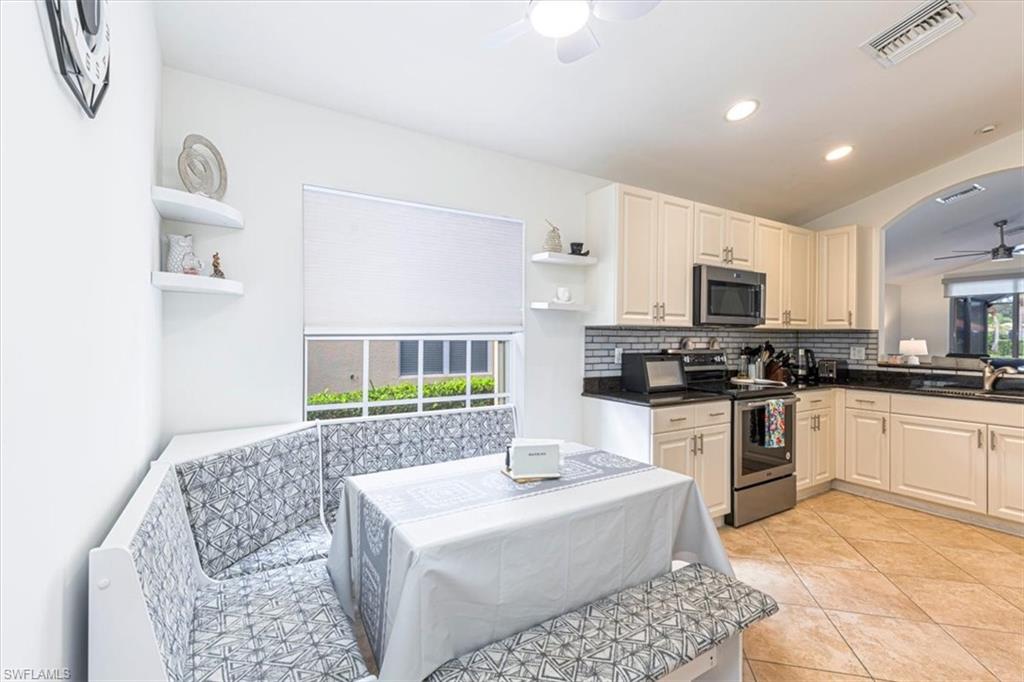 1630 Triangle Palm Terrace Naples, FL 34119 - Photo 6 of 24 a kitchen with stainless steel appliances kitchen island granite countertop a sink and a white cabinets