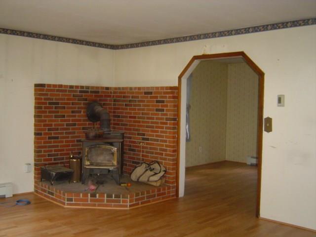 294 Merrill Hill Road Hebron, ME 04238 - Photo 4 of 23 The living room has a wood stove and...