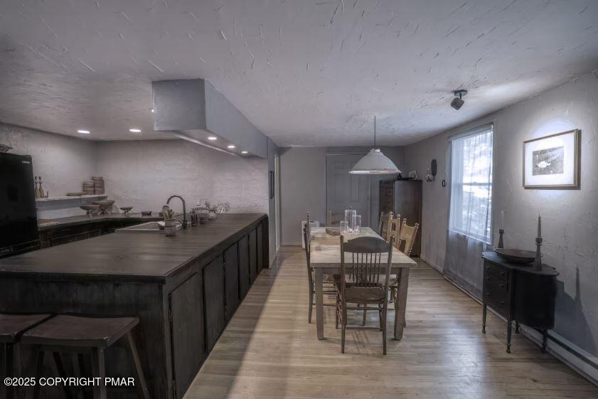 169 Saunders Drive Bushkill, PA 18324 - Photo 8 of 100 a kitchen with granite countertop a sink dining table and chairs