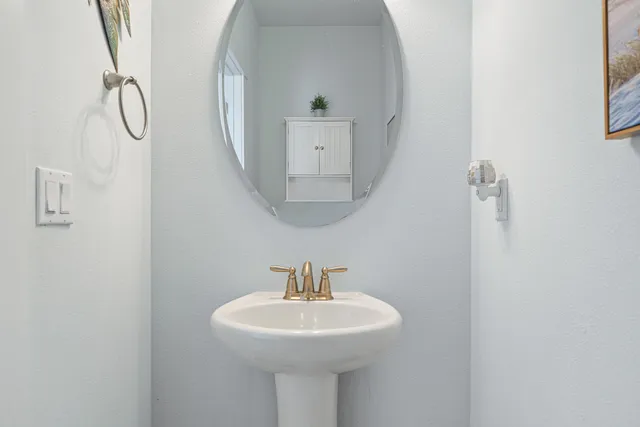 a bathroom with a sink a mirror and a toilet