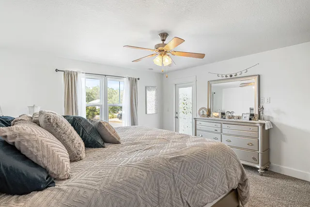 a bedroom with a large bed and a chandelier