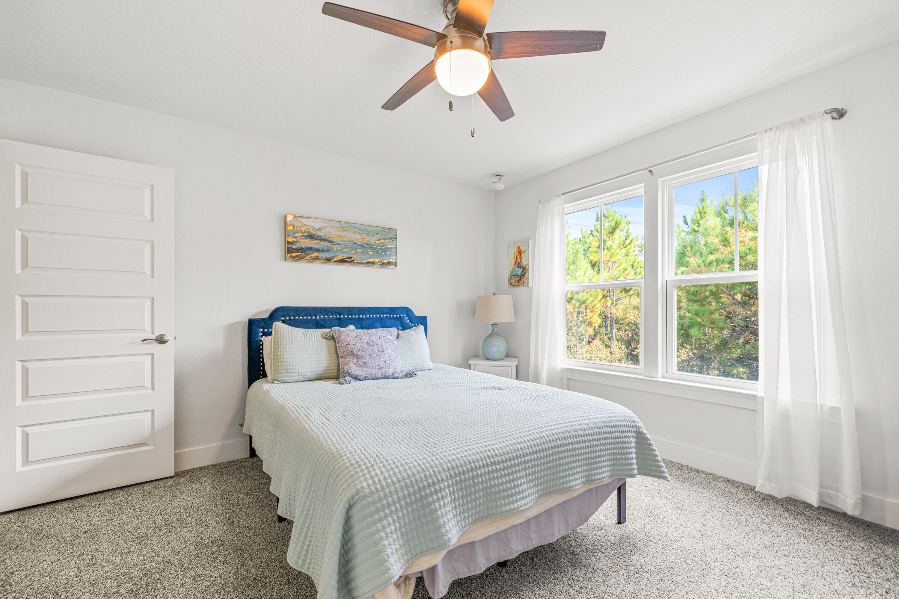 178 Melrose Avenue Santa Rosa Beach, FL 32459 - Photo 28 of 45 a bedroom with a bed and a chandelier