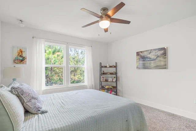 a bed sitting in a bedroom next to a window