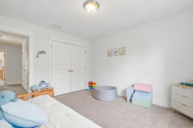 a bedroom with furniture and a potted plant