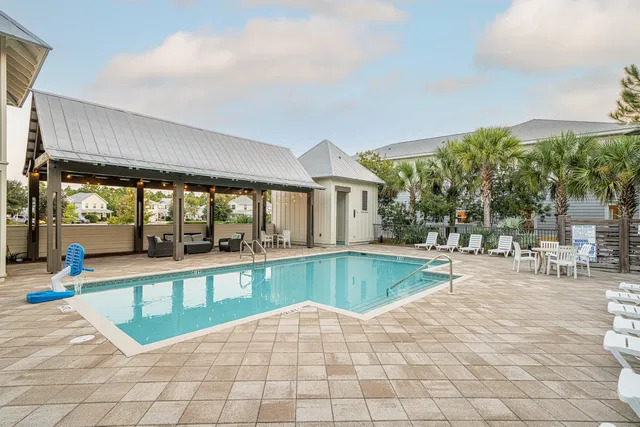 a view of a patio with swimming pool table and chairs