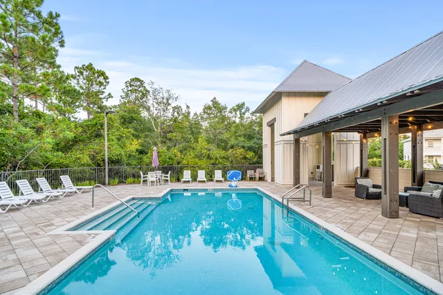 a swimming pool with outdoor seating and yard