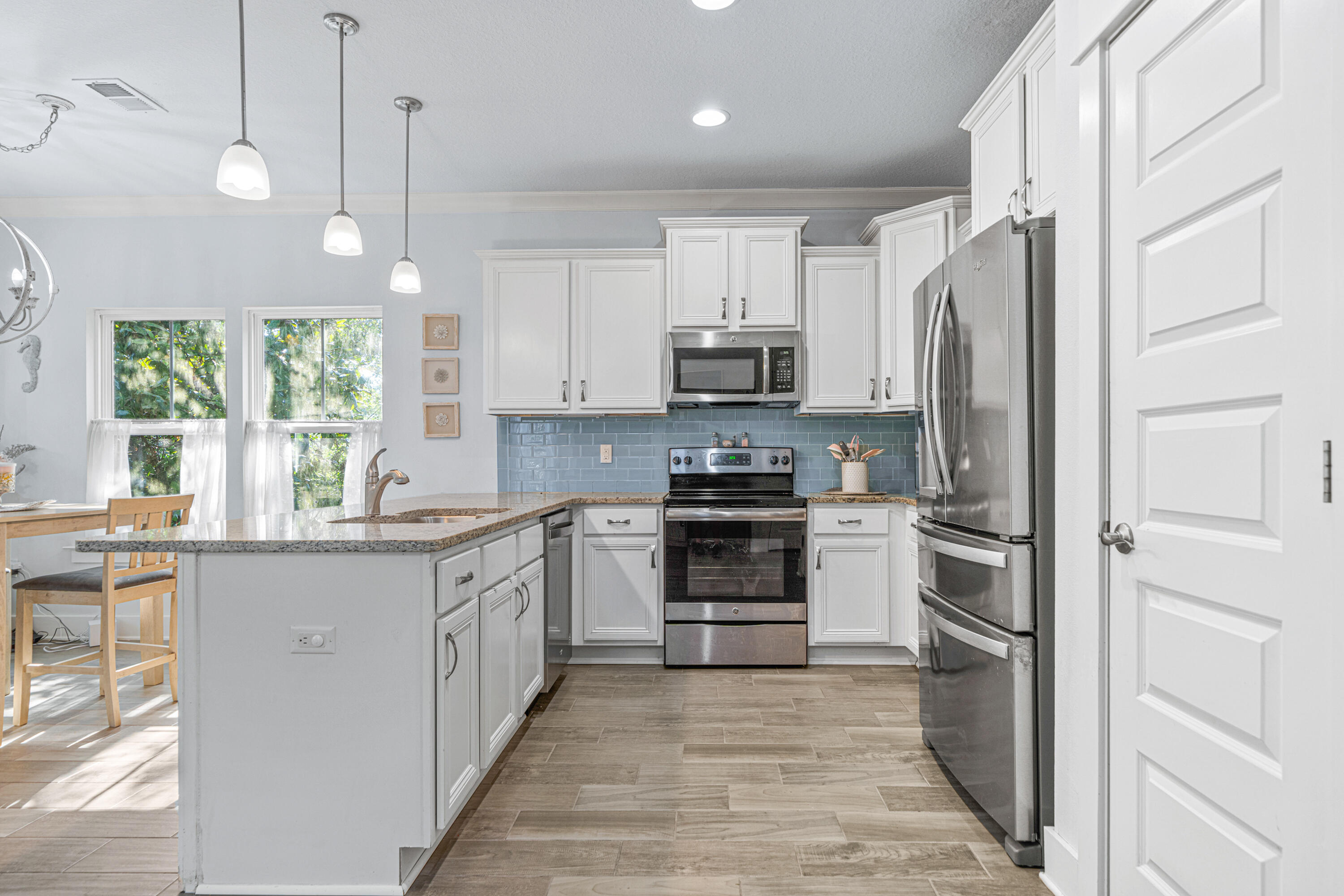178 Melrose Avenue Santa Rosa Beach, FL 32459 - Photo 6 of 45 a kitchen with stainless steel appliances a refrigerator sink and cabinets