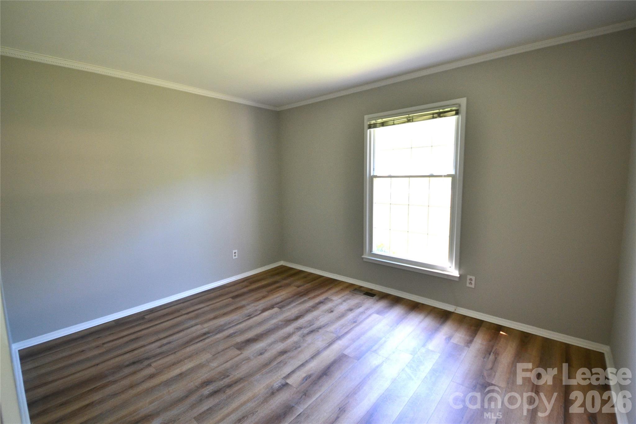 1422 Thermal Road Charlotte, NC 28212 - Photo 20 of 40 an empty room with wooden floor and windows