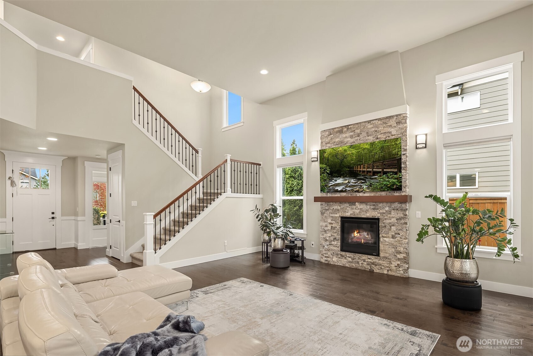 1435 242nd Place Southeast Bothell, WA 98021 - Photo 13 of 40 a living room with furniture a flat screen tv and a fireplace