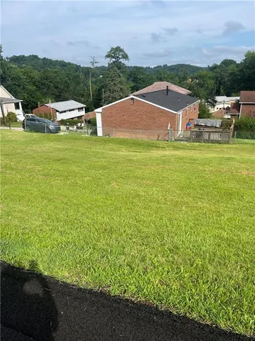 a view of a swimming pool and trees in the background