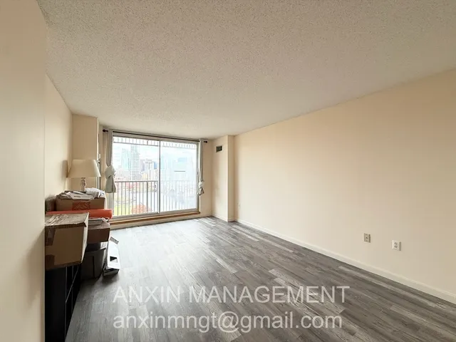 a view of an empty room and a window