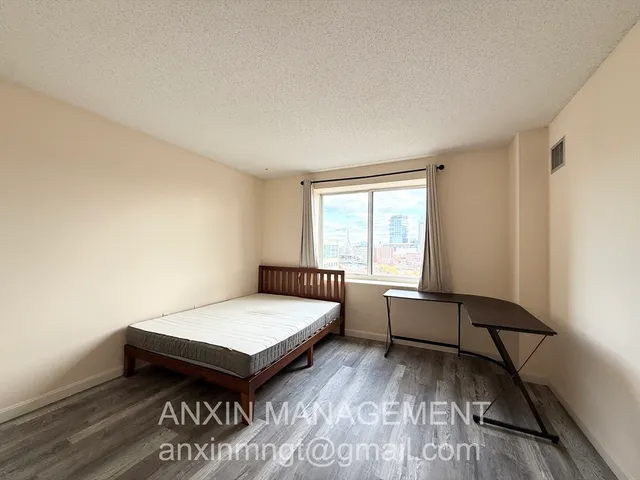 a living room with a bed furniture and a window