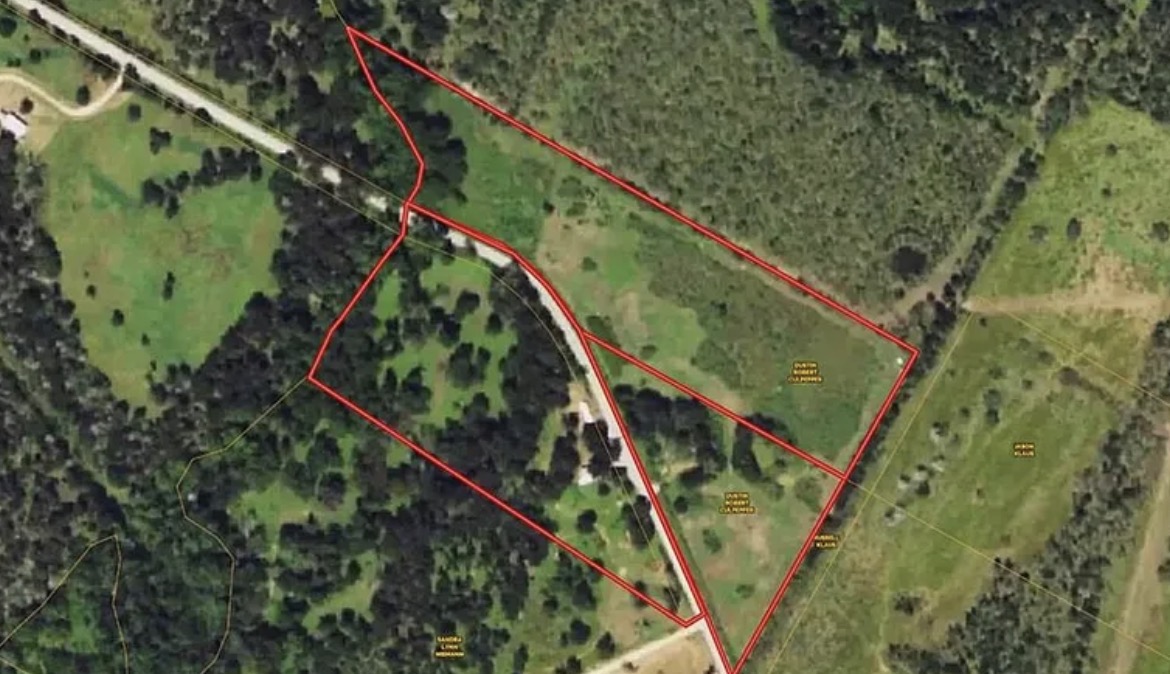 344-343 Bateman Road Red Rock, TX 78662 - Photo 15 of 15 An aerial view showcases an expansive, naturally wooded lot with open clearings, ideal for development.