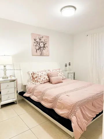 a bedroom with a bed and dresser