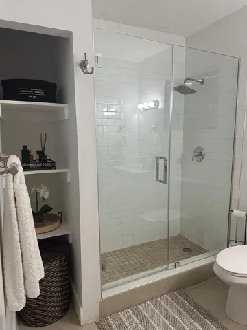 a bathroom with a shower a toilet and a sink