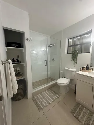 a bathroom with a toilet a sink and shower