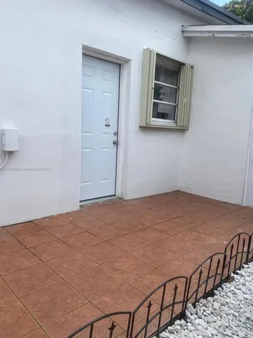 a bedroom with a bed and painting on the wall