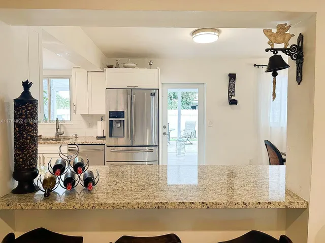 a kitchen with a refrigerator and a sink