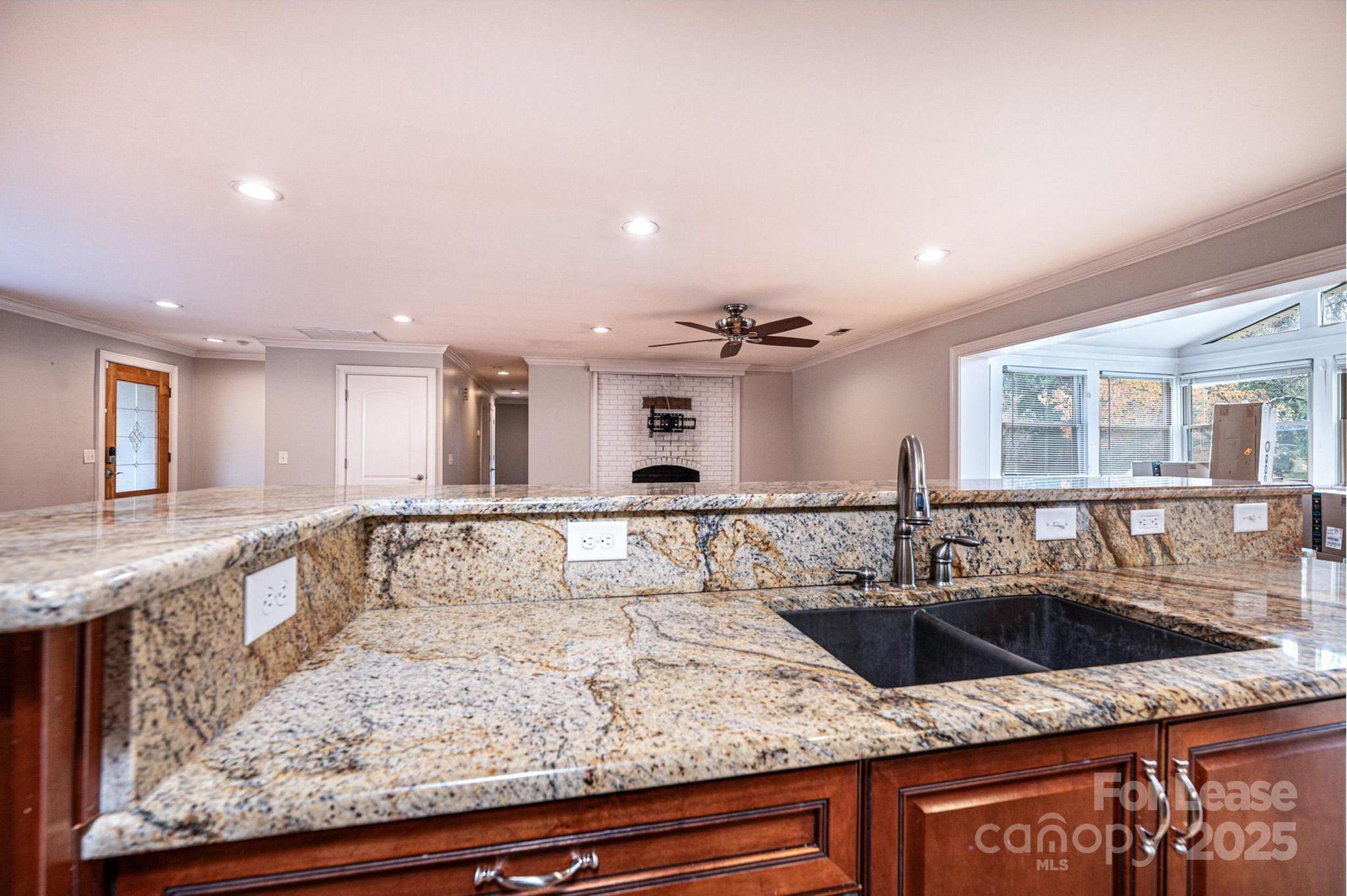 1060 26th Avenue Northeast Hickory, NC 28601 - Photo 12 of 29 a view of a kitchen with kitchen island a sink wooden floor and glass doors