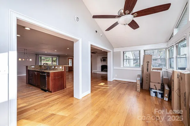 a view of a livingroom with wooden floor and furniture