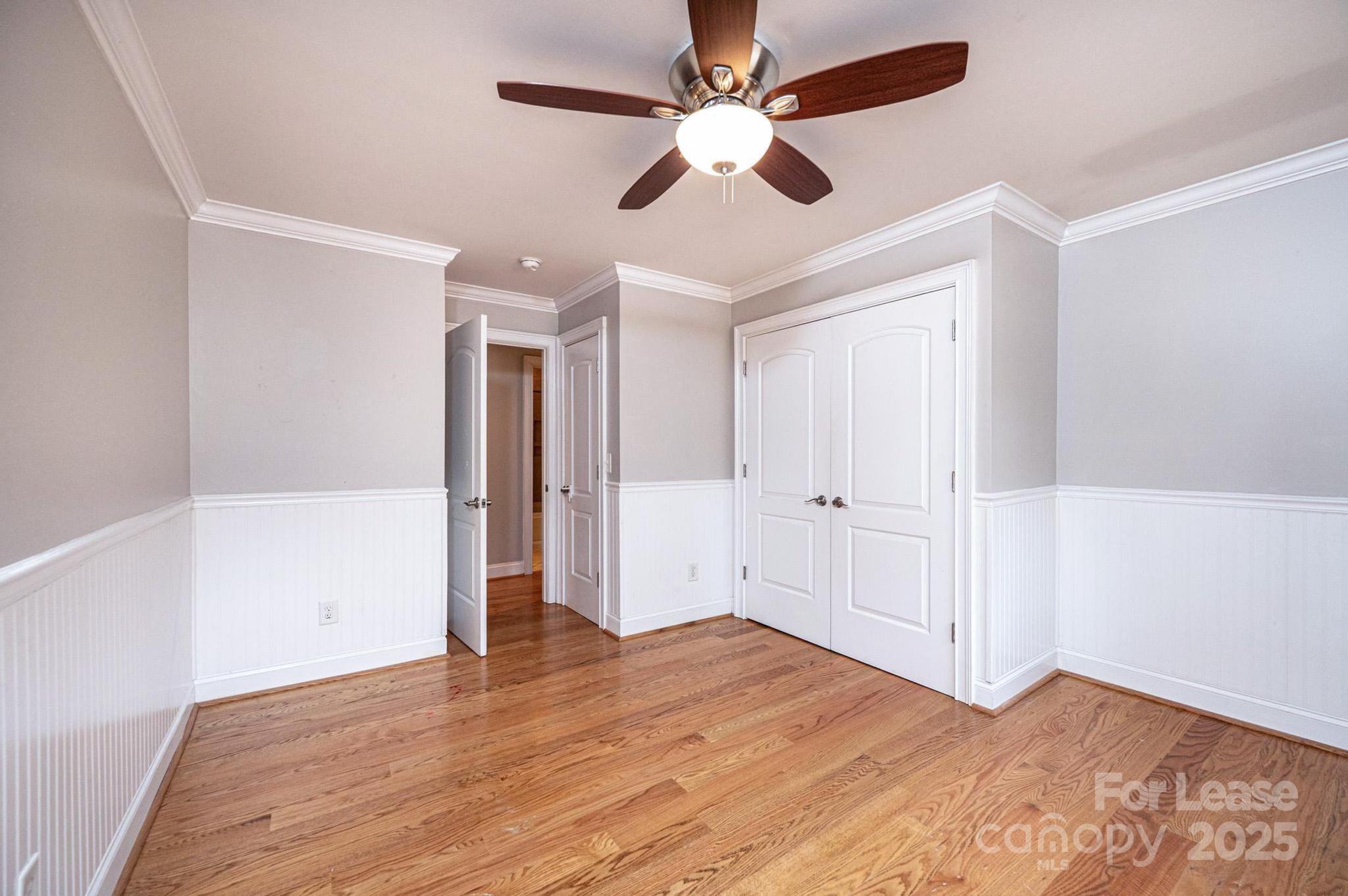 1060 26th Avenue Northeast Hickory, NC 28601 - Photo 23 of 29 an empty room with wooden floor and ceiling fan