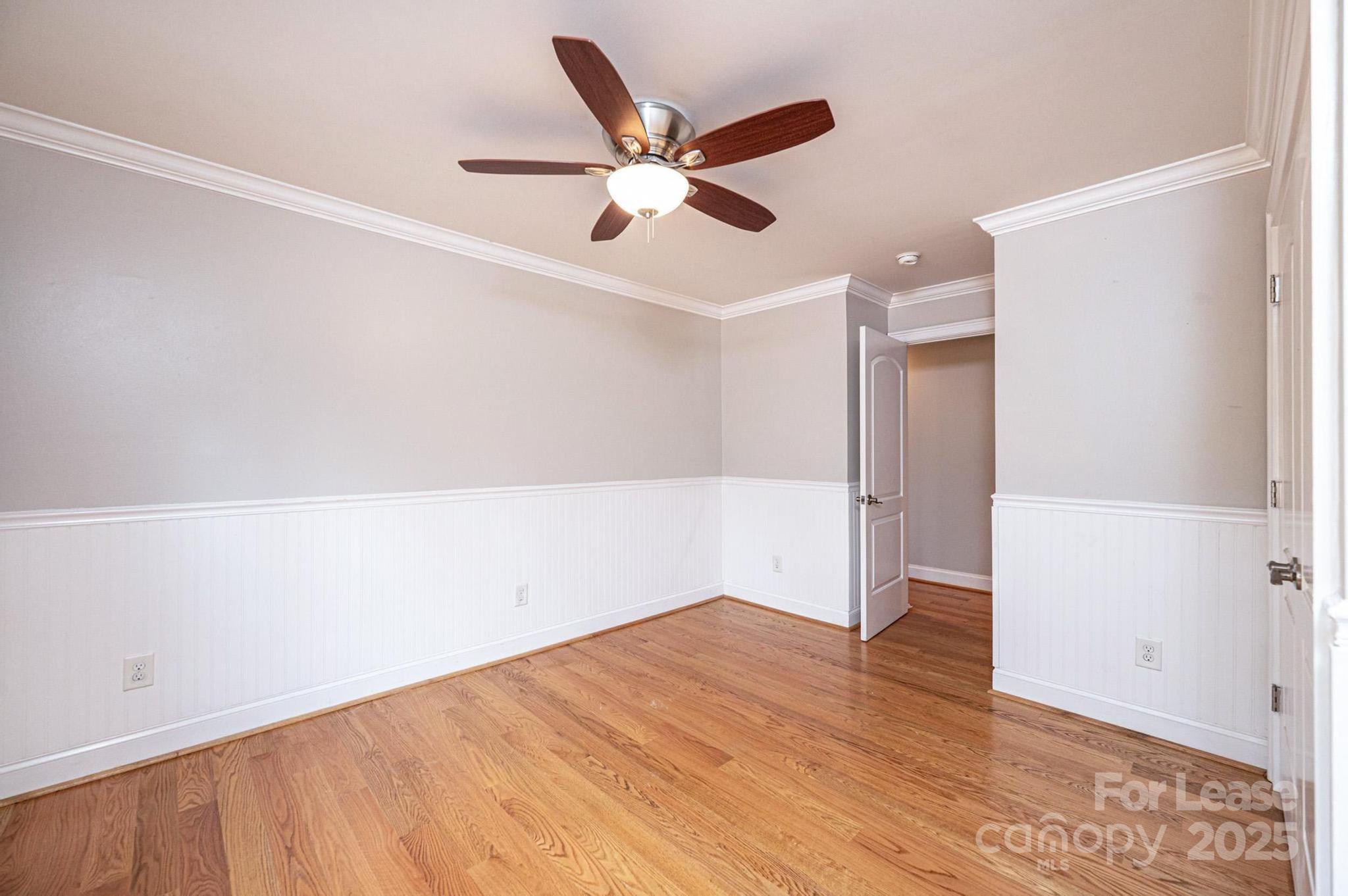 1060 26th Avenue Northeast Hickory, NC 28601 - Photo 25 of 29 an empty room with wooden floor and ceiling fan