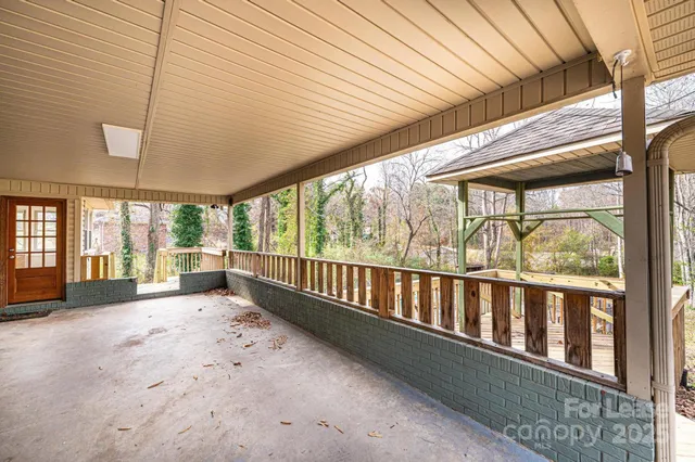 a view of a porch with wooden floor and furniture