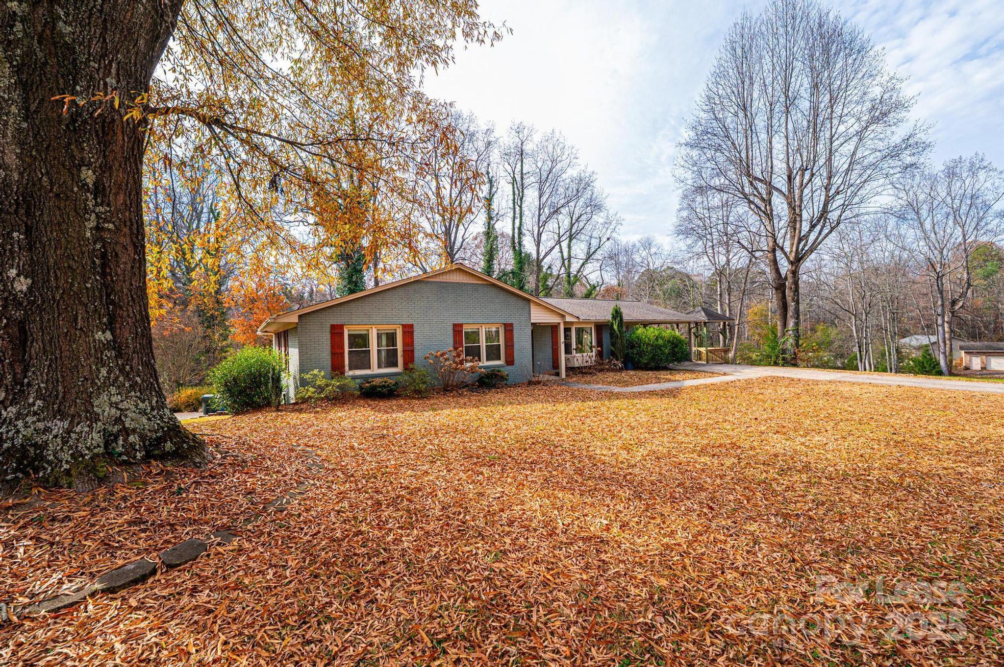 1060 26th Avenue Northeast Hickory, NC 28601 - Photo 3 of 29 a front view of a house with a yard and large trees