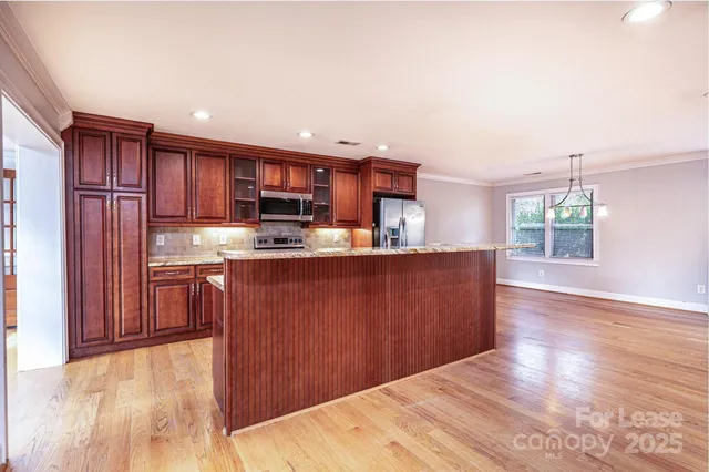 a kitchen with stainless steel appliances granite countertop a refrigerator sink and cabinets