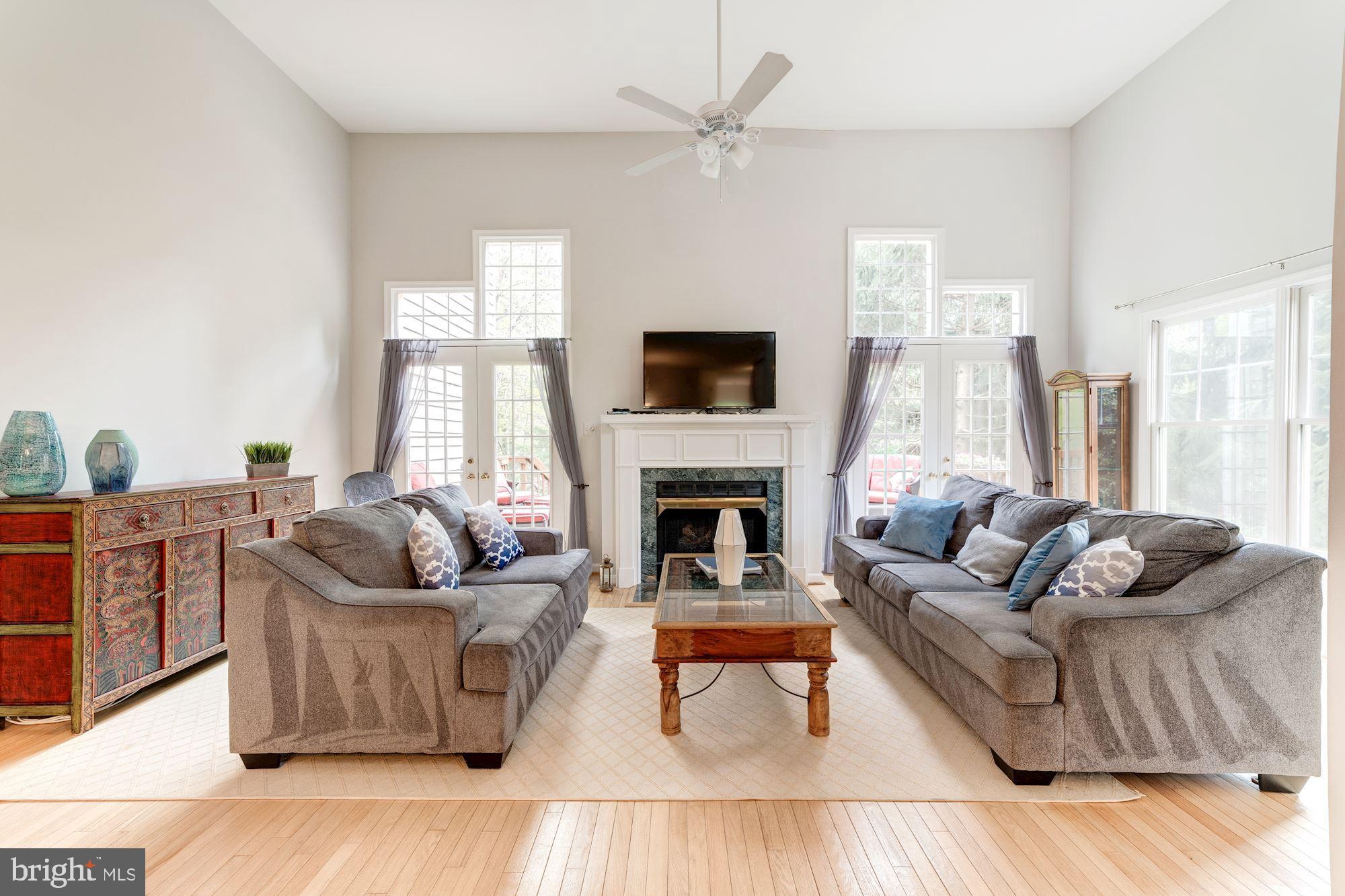 1283 Weatherstone Court Reston, VA 20194 - Photo 13 of 38 a living room with furniture and a fireplace