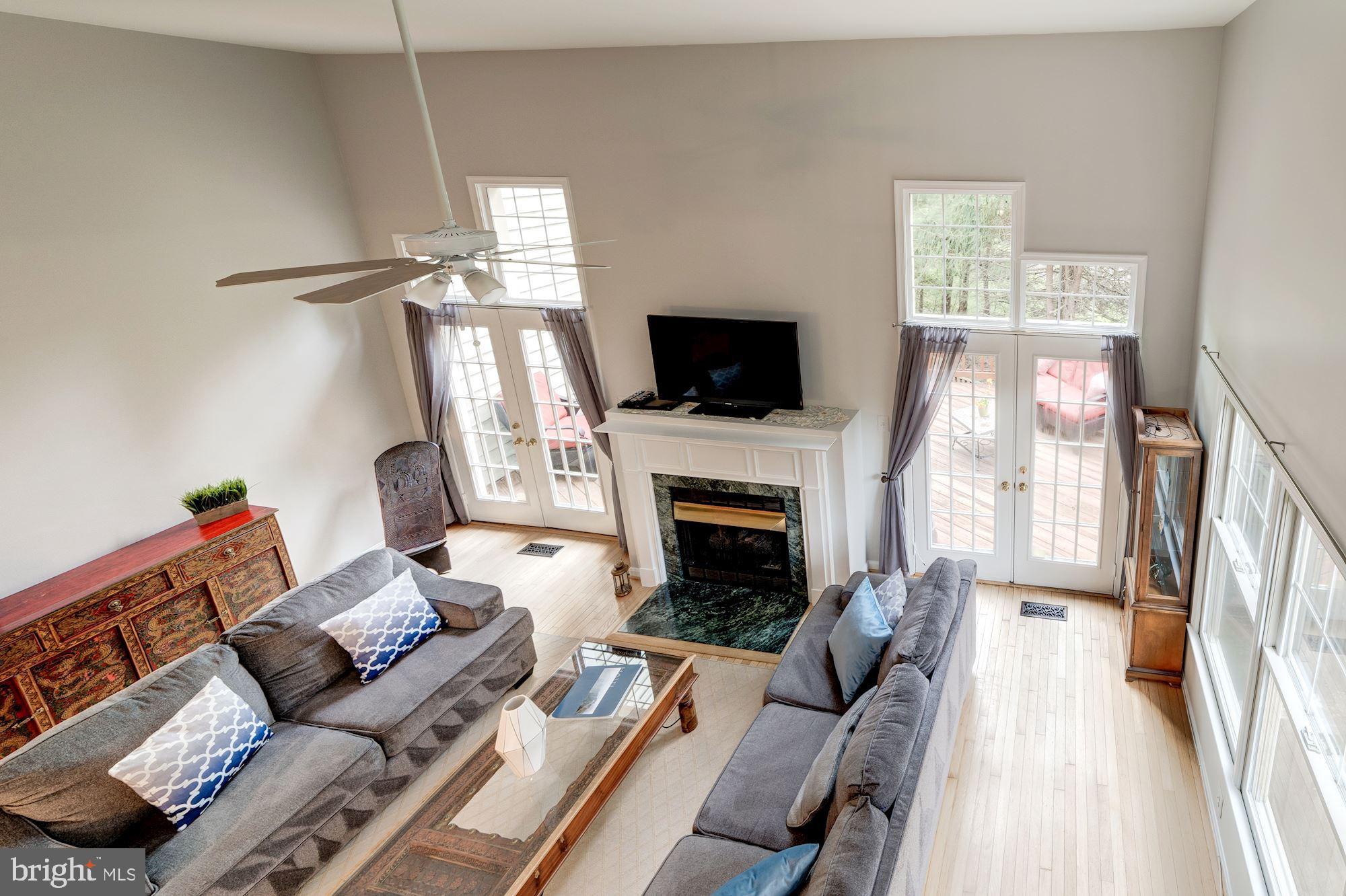 1283 Weatherstone Court Reston, VA 20194 - Photo 15 of 38 a living room with furniture a flat screen tv and a fireplace