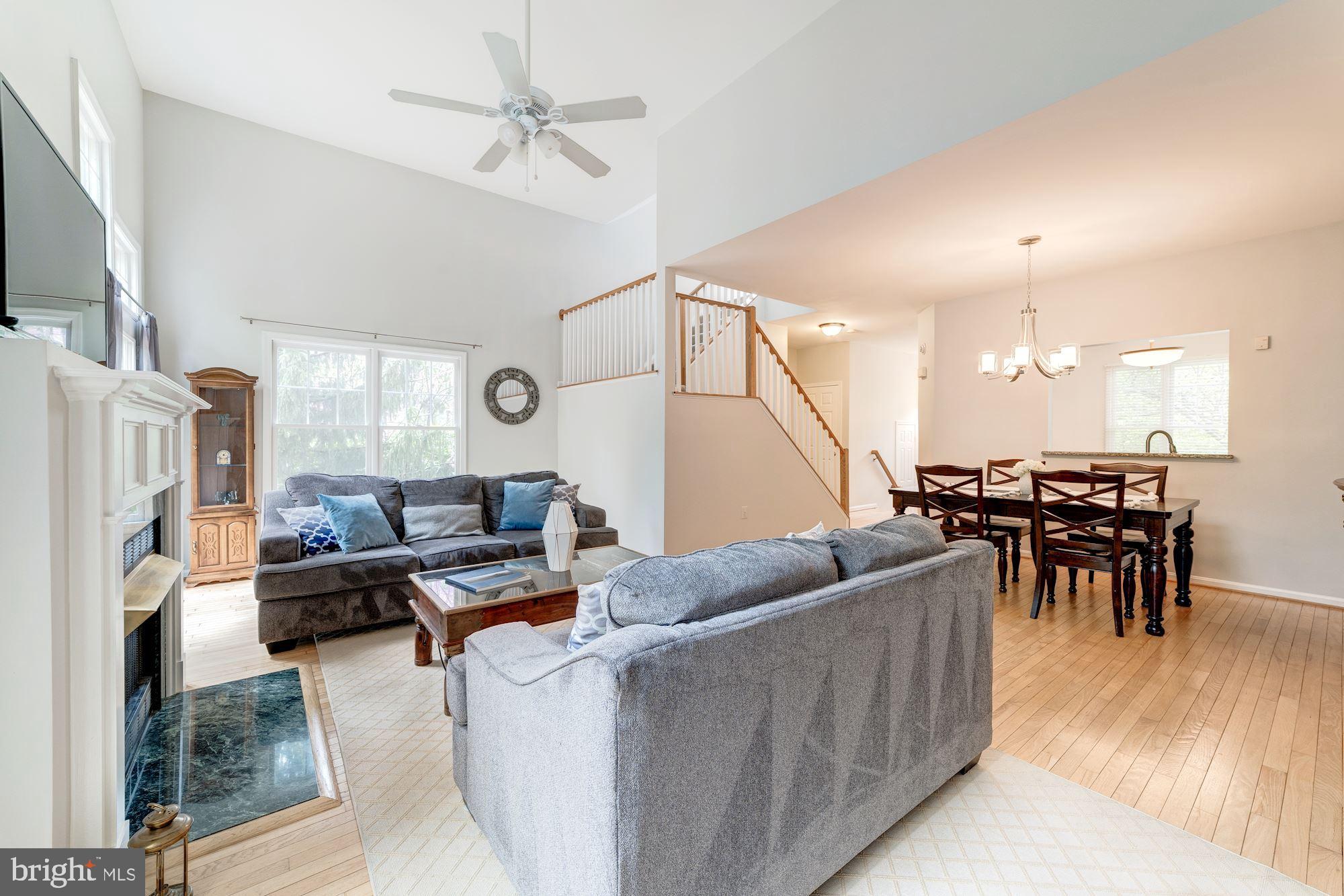 1283 Weatherstone Court Reston, VA 20194 - Photo 16 of 38 a living room with furniture and a flat screen tv