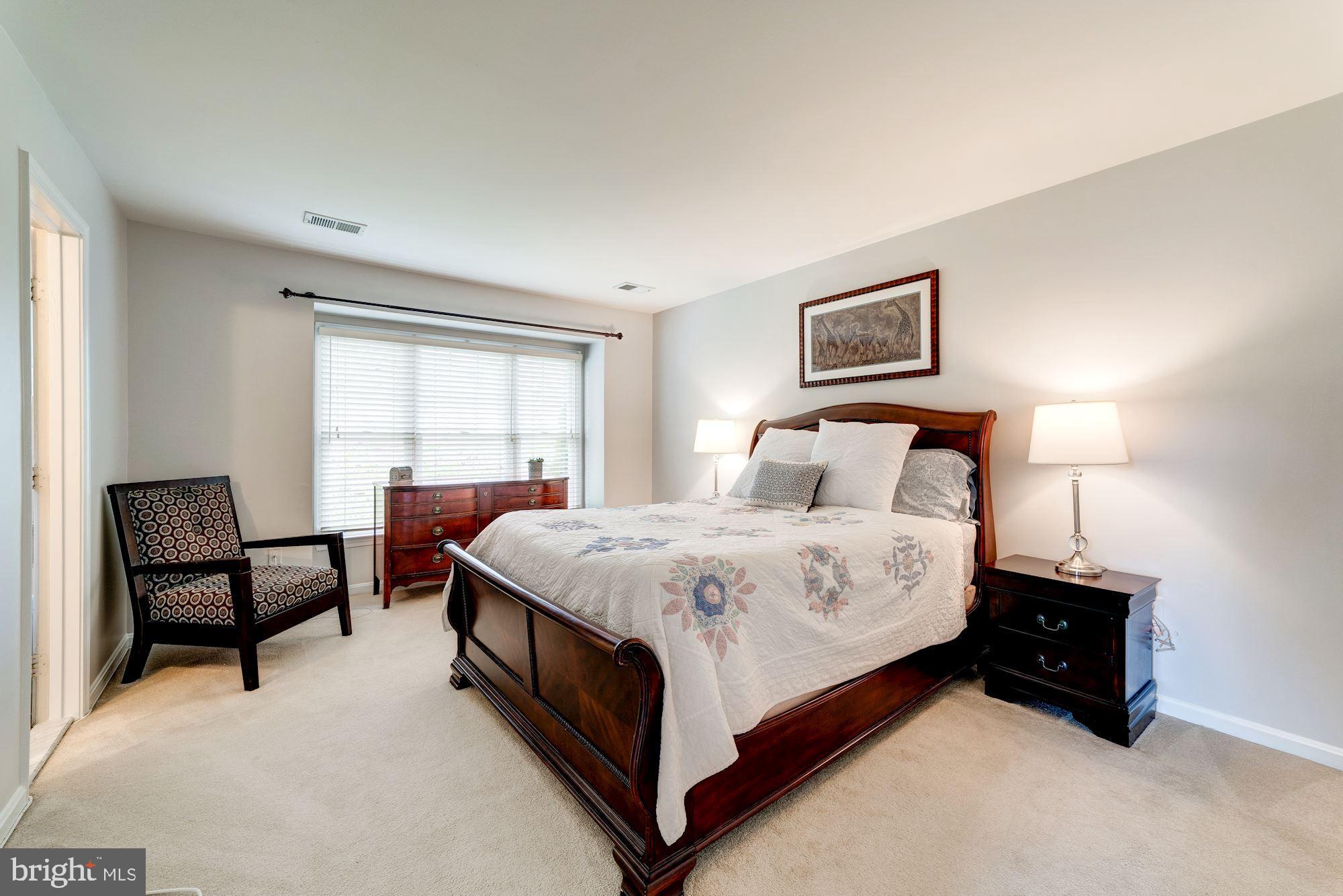 1283 Weatherstone Court Reston, VA 20194 - Photo 17 of 38 a spacious bedroom with a bed and a window