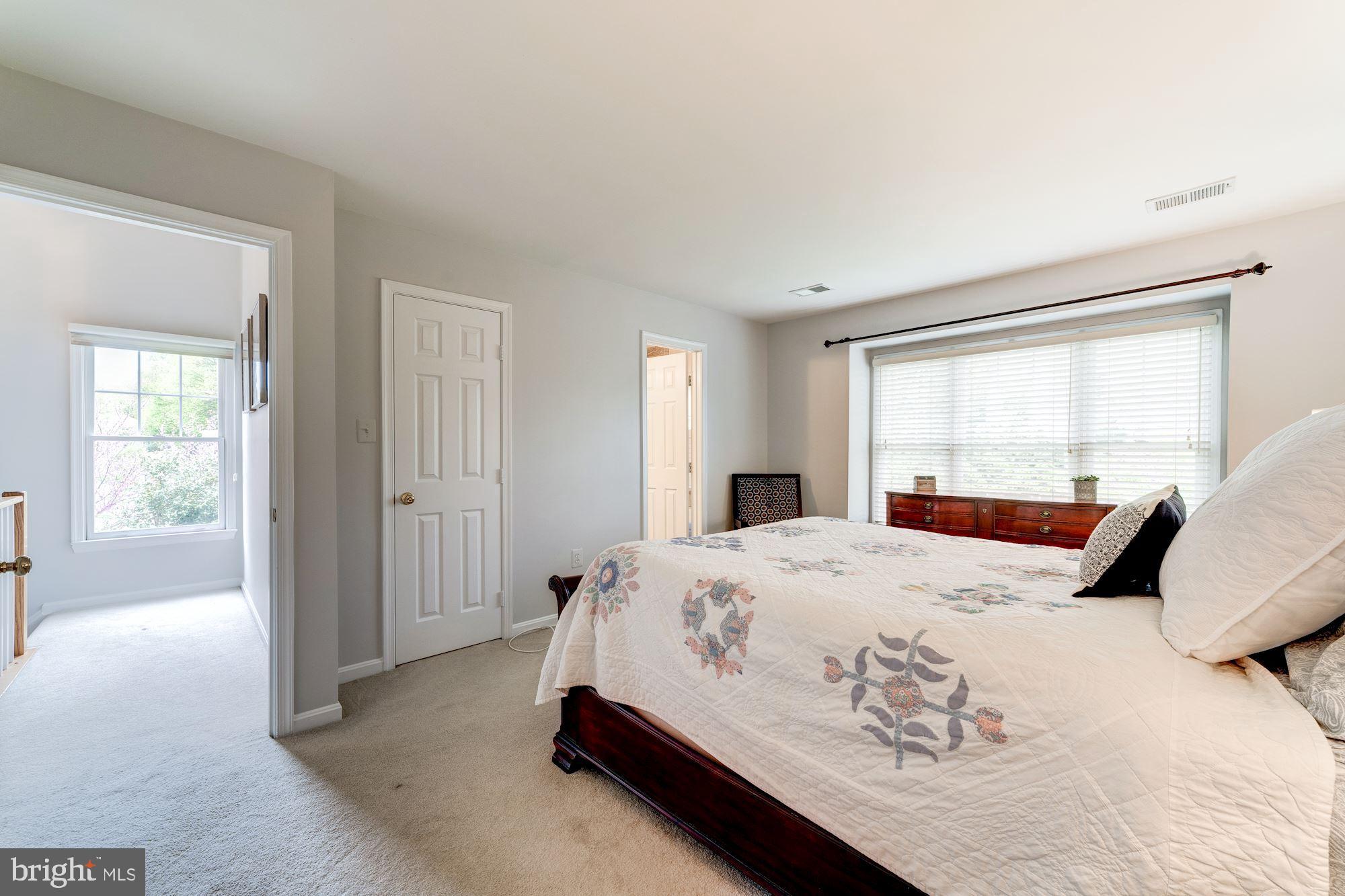 1283 Weatherstone Court Reston, VA 20194 - Photo 18 of 38 a bedroom with a large bed and a window
