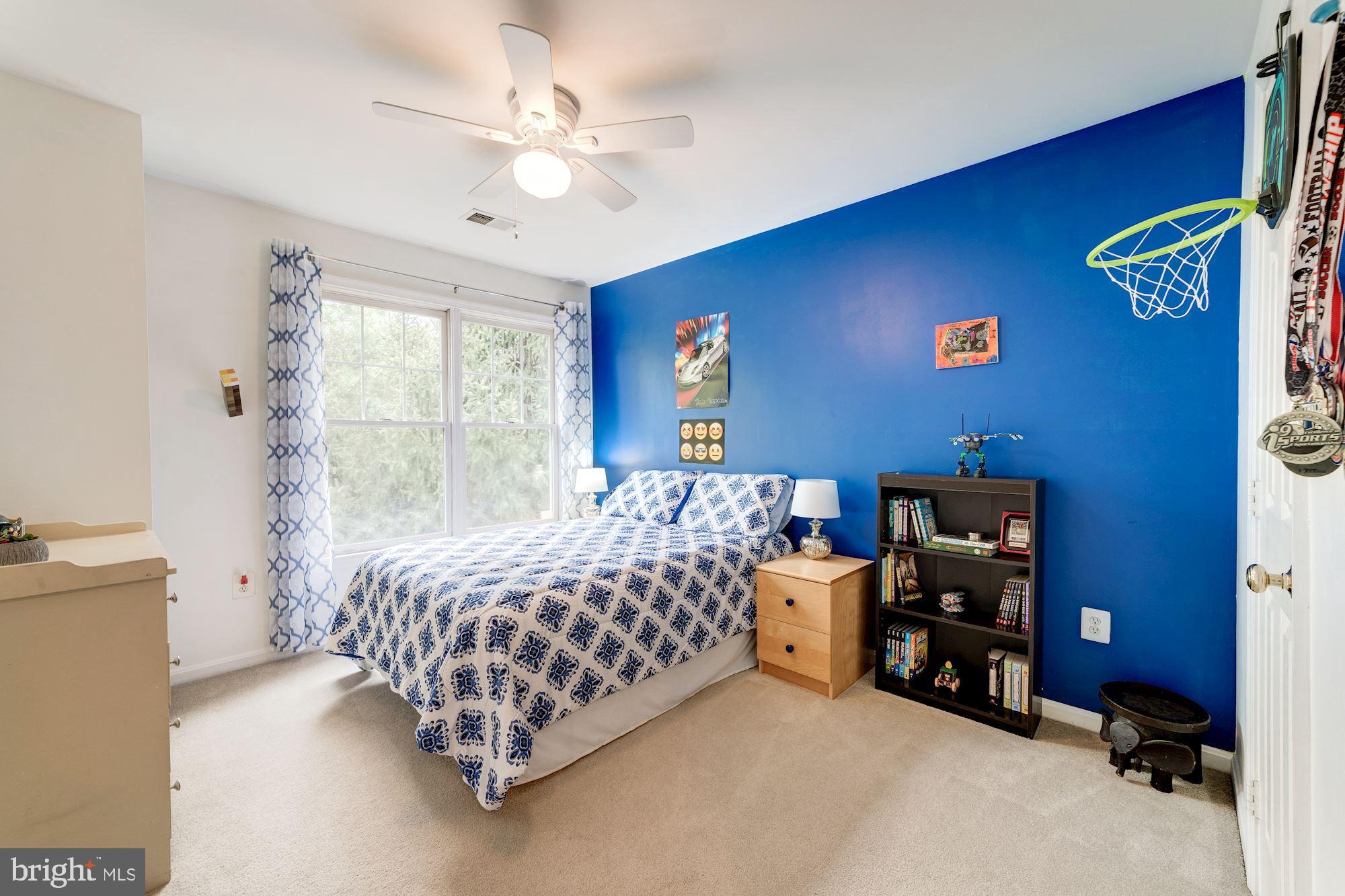 1283 Weatherstone Court Reston, VA 20194 - Photo 23 of 38 a bedroom with bed and a chandelier