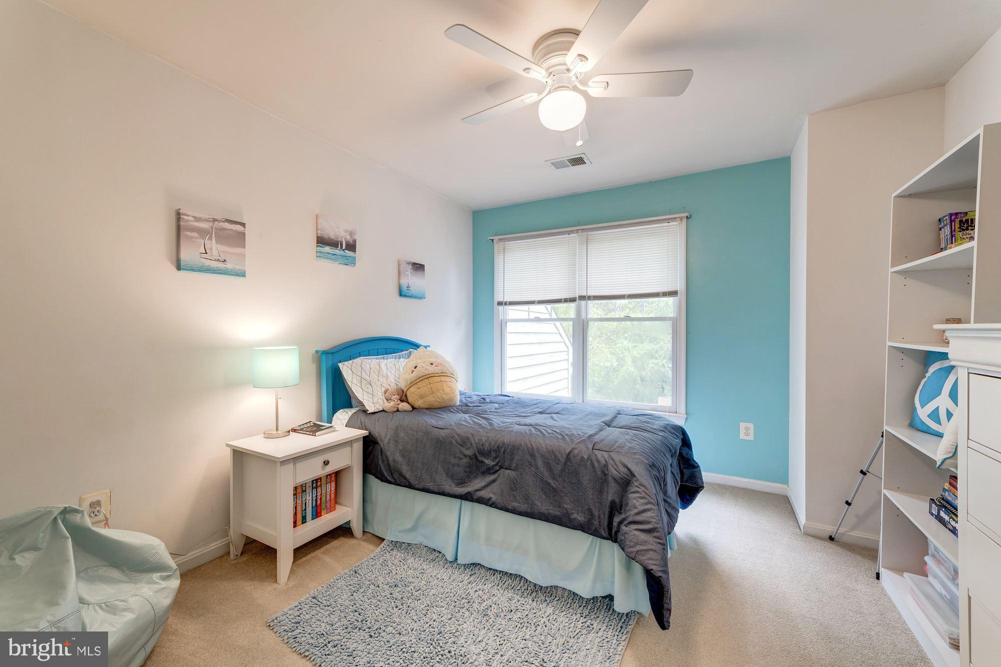1283 Weatherstone Court Reston, VA 20194 - Photo 24 of 38 a bedroom with a bed and a chandelier