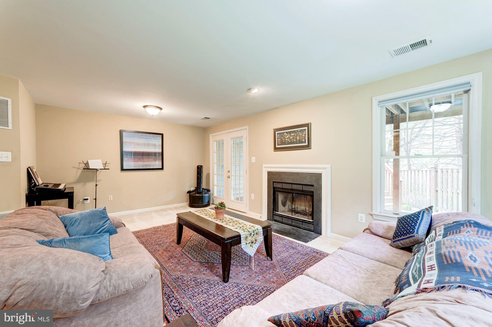 1283 Weatherstone Court Reston, VA 20194 - Photo 26 of 38 a living room with furniture and a fireplace