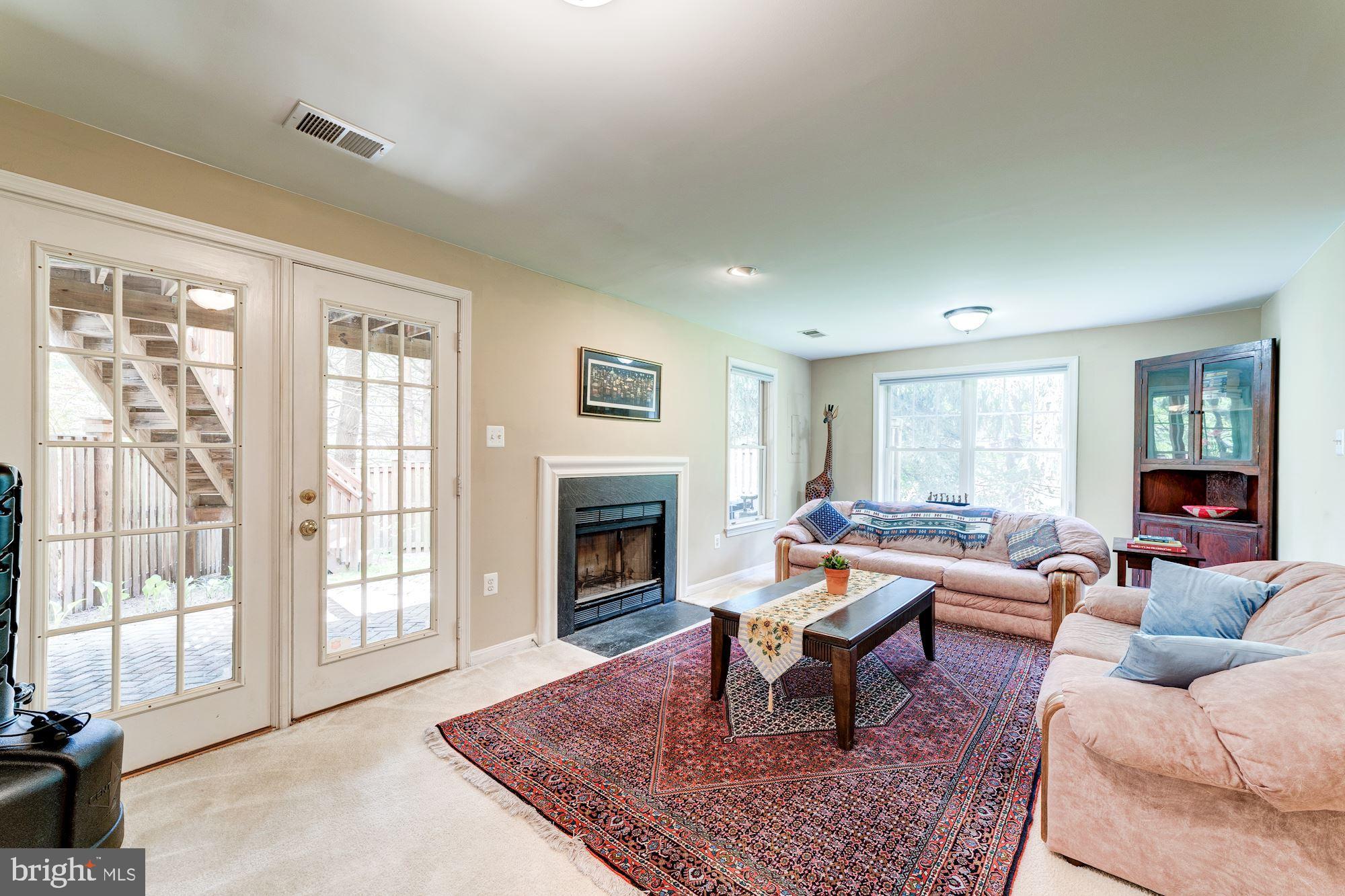 1283 Weatherstone Court Reston, VA 20194 - Photo 27 of 38 a living room with furniture or couch and a fireplace