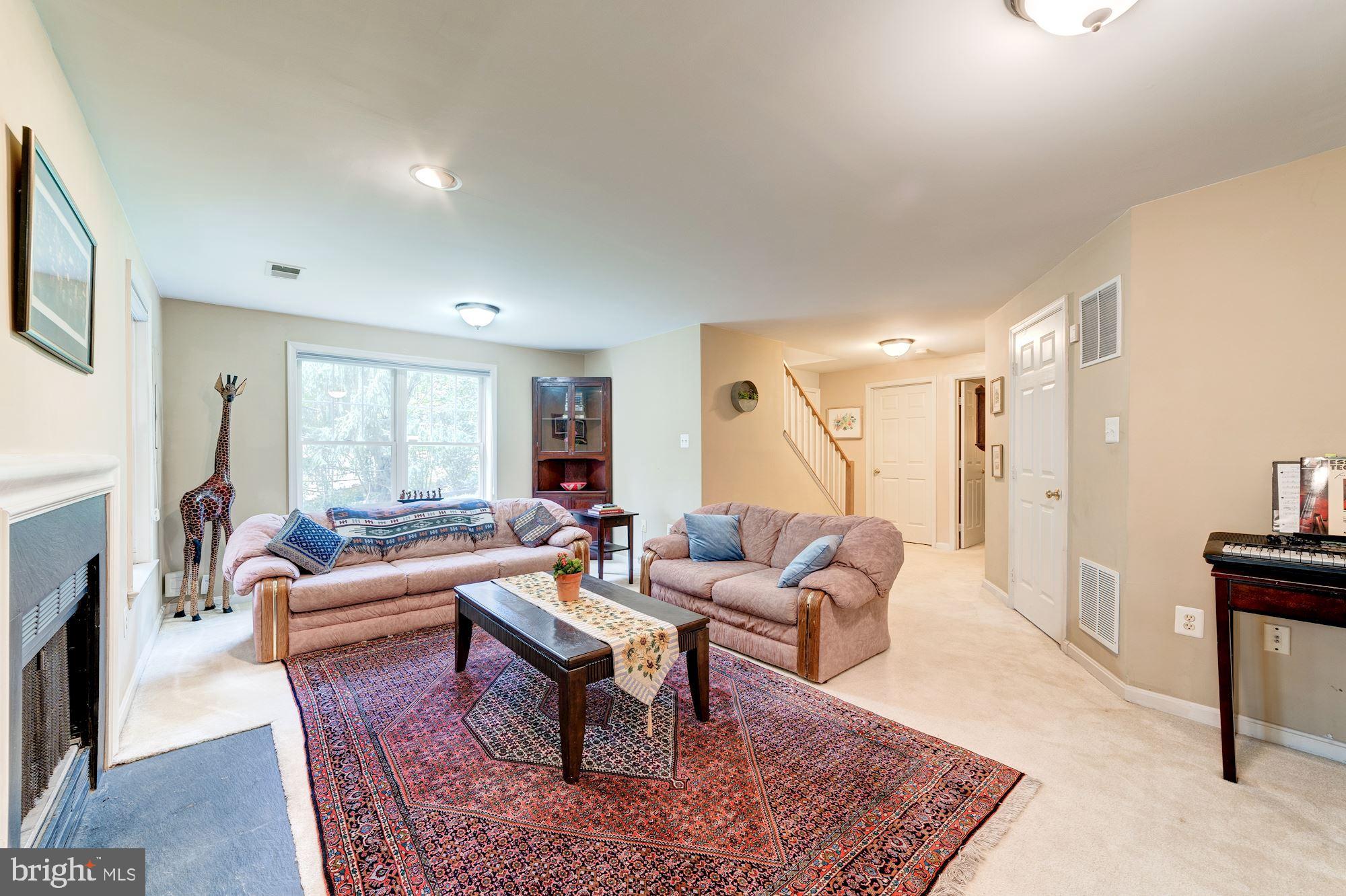 1283 Weatherstone Court Reston, VA 20194 - Photo 28 of 38 a living room with fireplace furniture and a rug