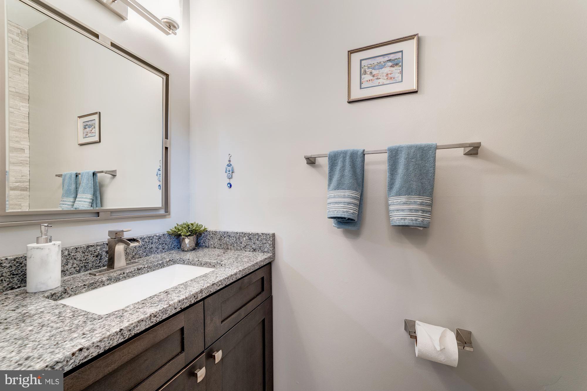 1283 Weatherstone Court Reston, VA 20194 - Photo 4 of 38 a bathroom with a granite countertop sink and a mirror