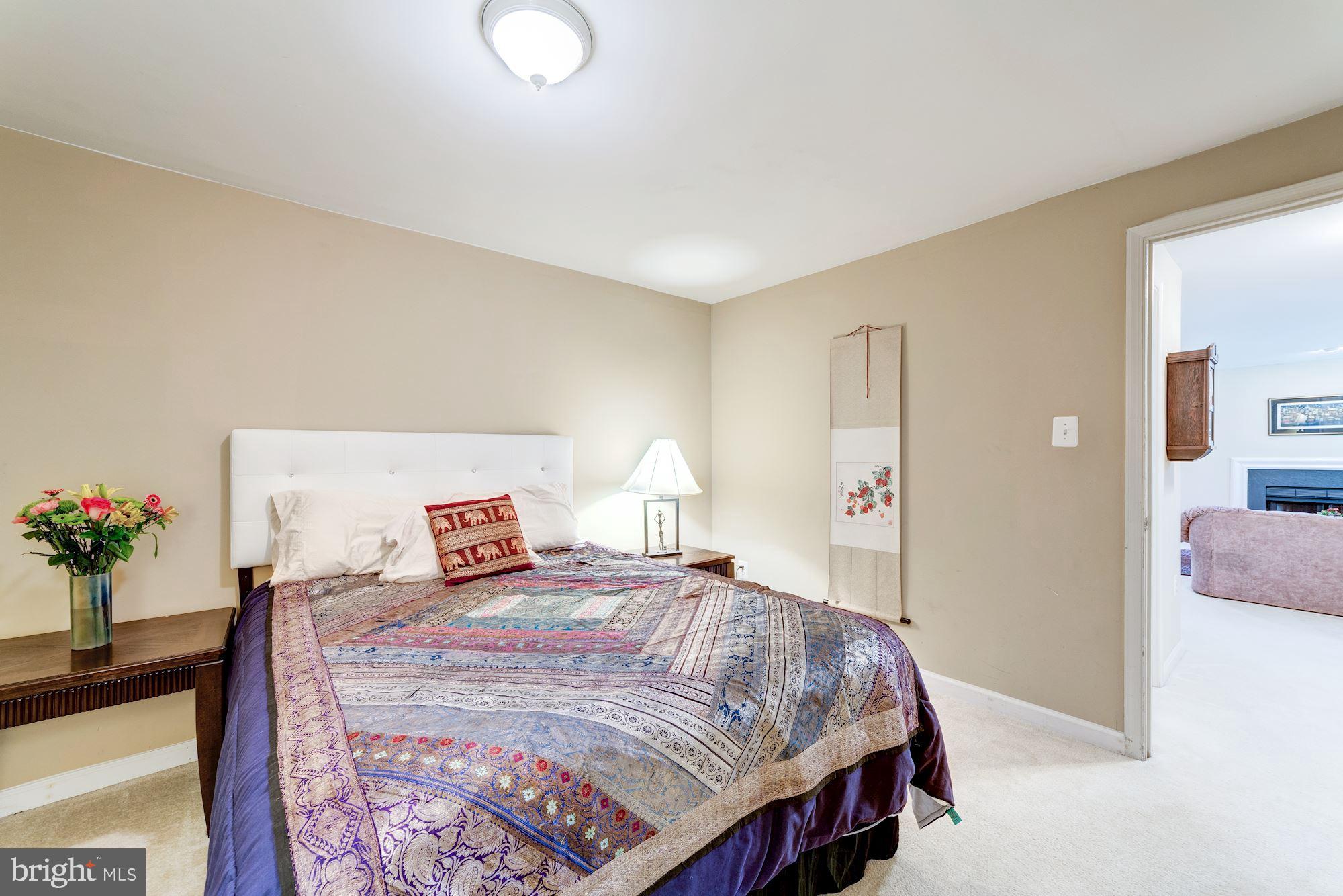 1283 Weatherstone Court Reston, VA 20194 - Photo 31 of 38 a bedroom with a bed and a chandelier