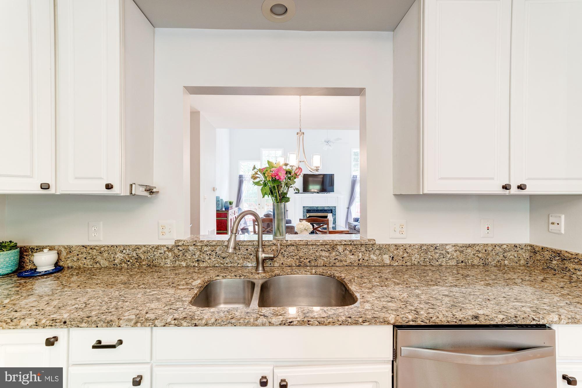 1283 Weatherstone Court Reston, VA 20194 - Photo 6 of 38 a kitchen with granite countertop a sink and cabinets