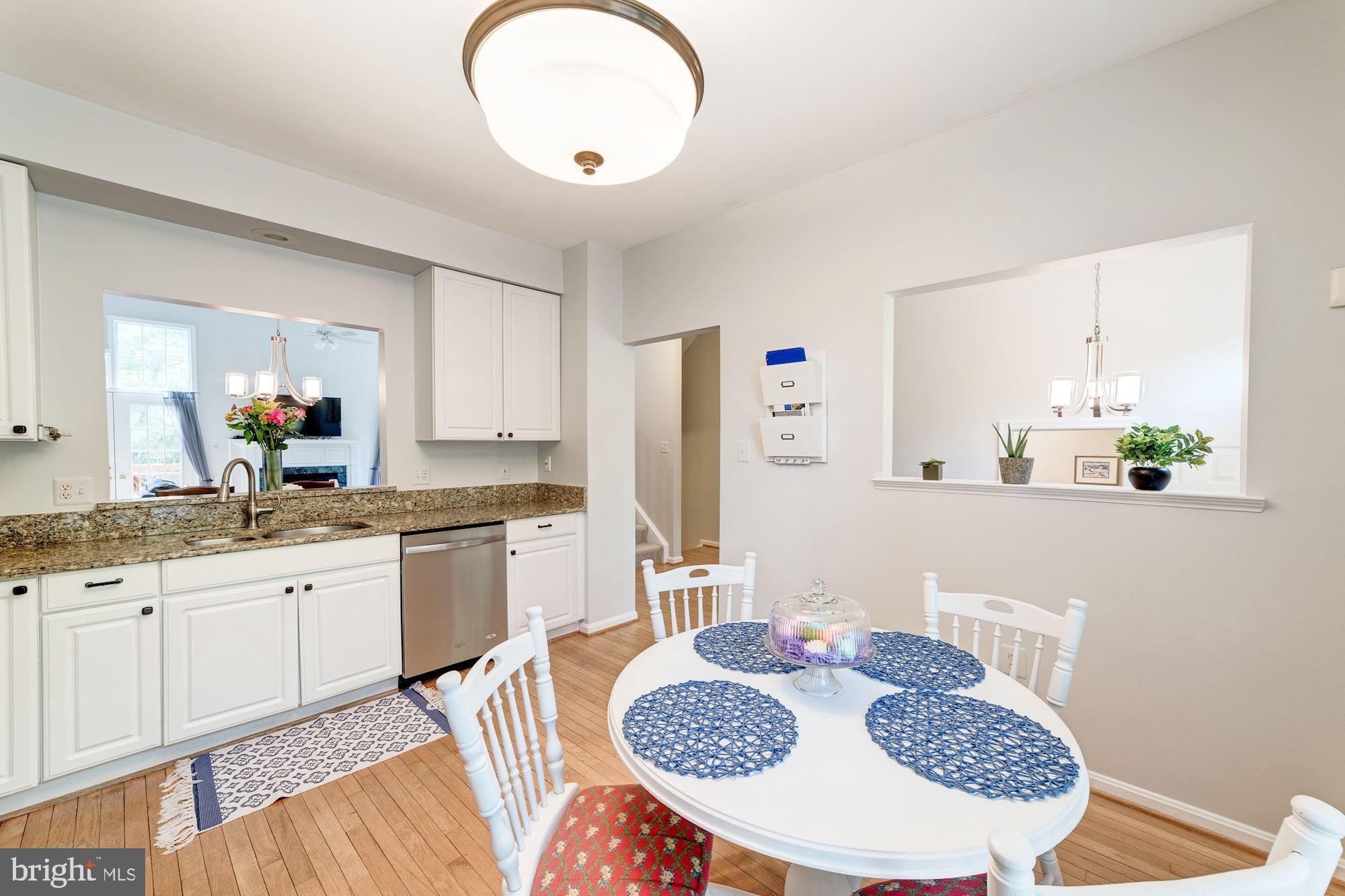 1283 Weatherstone Court Reston, VA 20194 - Photo 7 of 38 a kitchen with granite countertop kitchen island stainless steel appliances a sink and a refrigerator