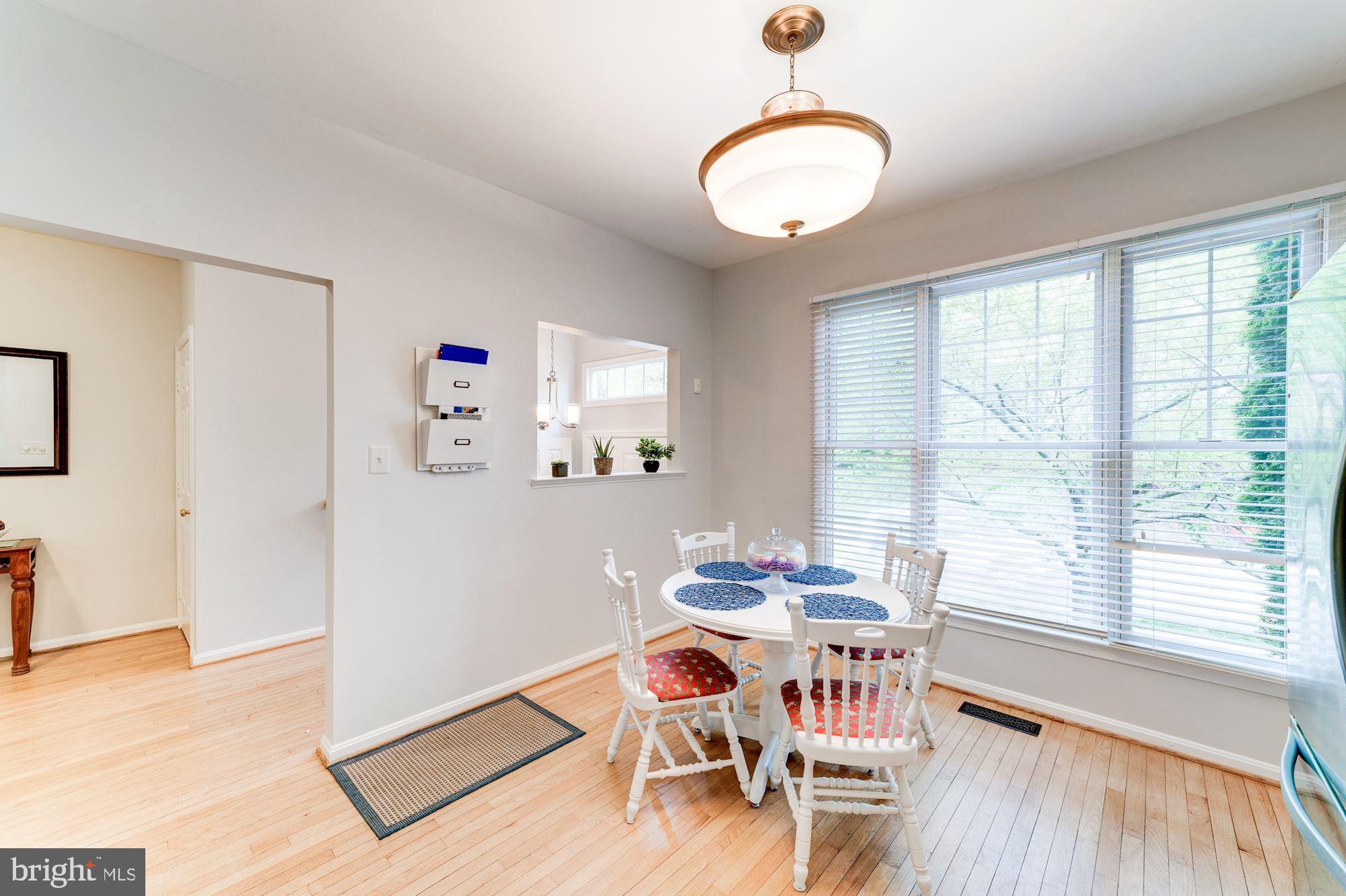 1283 Weatherstone Court Reston, VA 20194 - Photo 8 of 38 a dining room with furniture and wooden floor